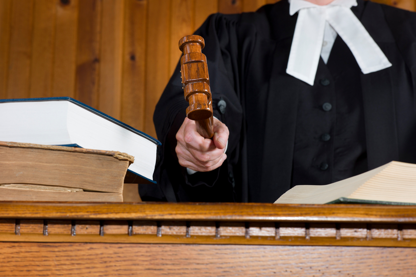 A judge hits the desk or bench with a Gavel during a trial.