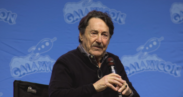 Peter Cullen holding a microphone