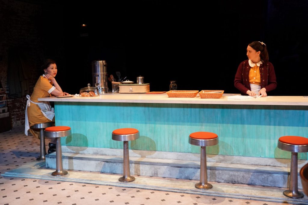 (L to R): Cindy Cheung, Delphi Borich in 'Bus Stop' (Carol Rosegg)